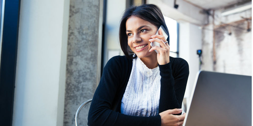 Happy business woman on phone with outsourced call center